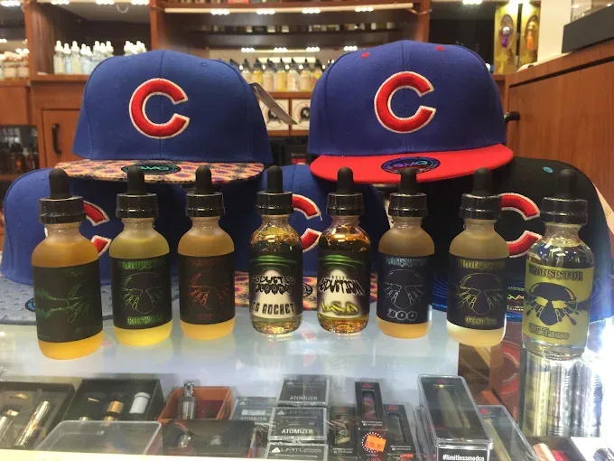 Vape liquids and Chicago themed hats in a Happy Daze display